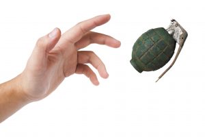 hand throwing a grenade isolated on white