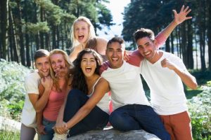 Group Of Young People Relaxing In Countryside