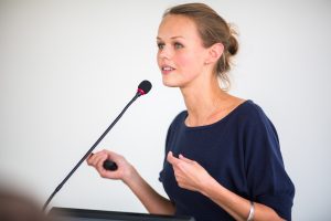 Pretty, young business woman giving a presentation